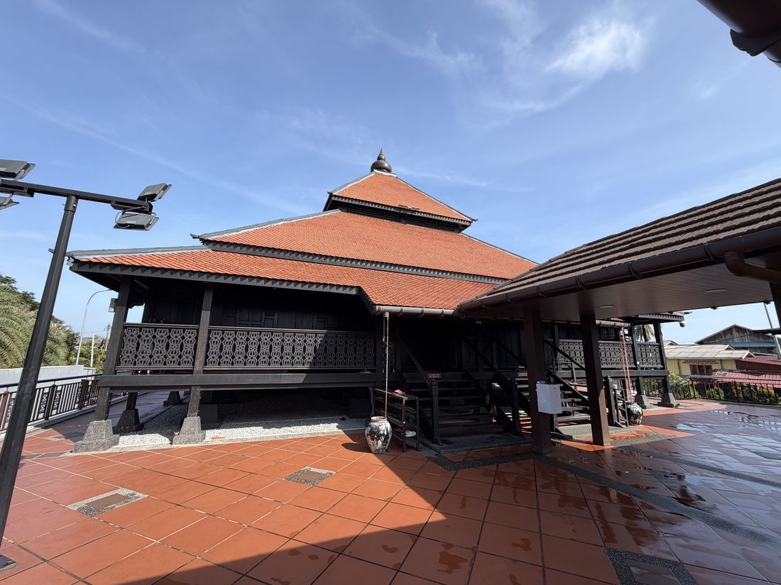 Masjid Kampung Laut, a timber mosque with a tiered pyramidal roof raised on posts, with no dome or minaret