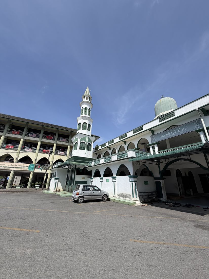 Masjid Tok Guru in Pulau Melaka, Kota Bharu, its minaret rising beside the school block across the courtyard