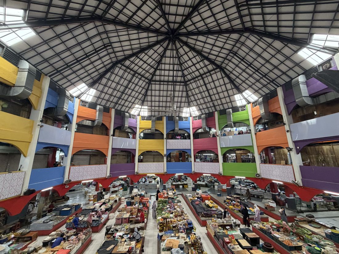 The interior of Pasar Siti Khadijah in Kota Bharu, women traders at stalls beneath a tiered roof